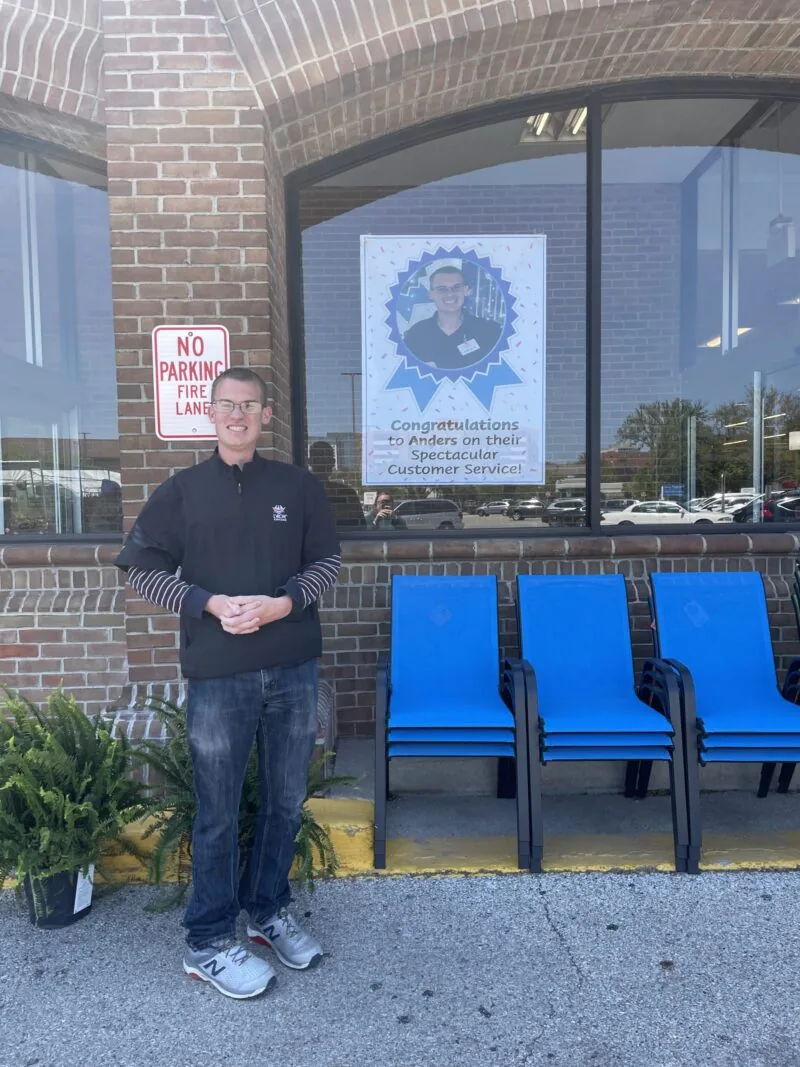 Anders stands outside Jewel by his poster